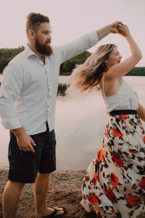Loving couple standing ankle deep in water on beach