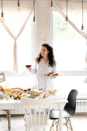 Woman standing beside table of food