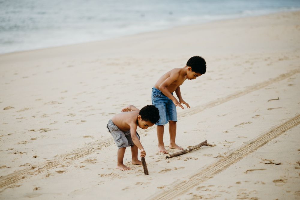Black boys playing on beach
