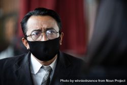 Concerned Asian business man wearing protective face mask 0vd7R4