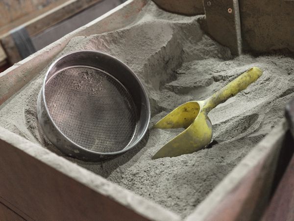 Metal strainer and plastic scoop on dry material