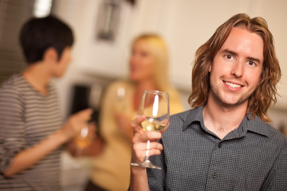 Smiling Man with Glass of Wine Socializing