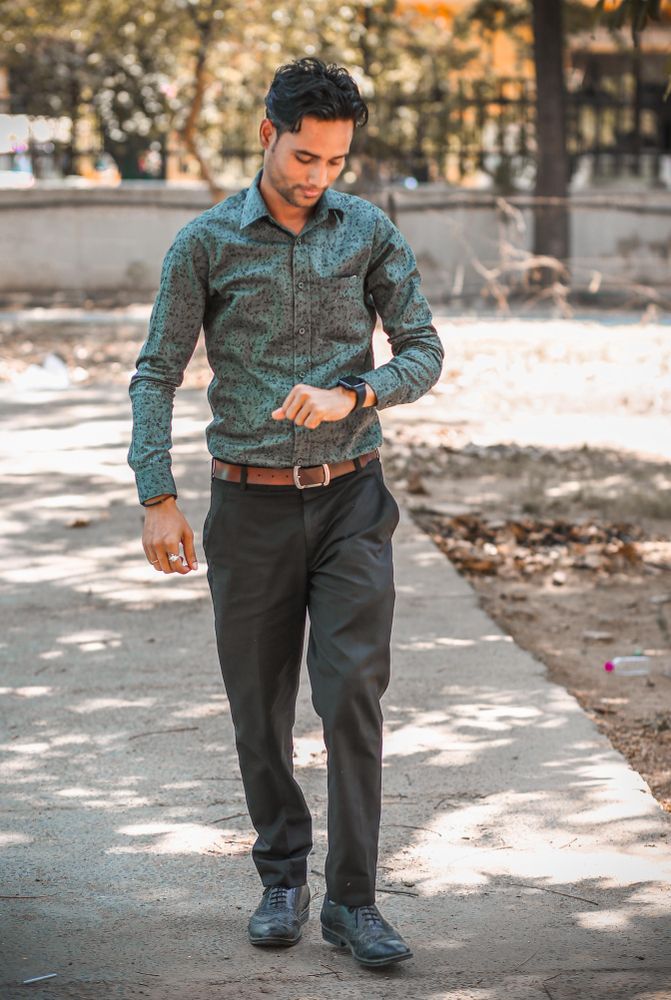 Man walking and looking at his watch