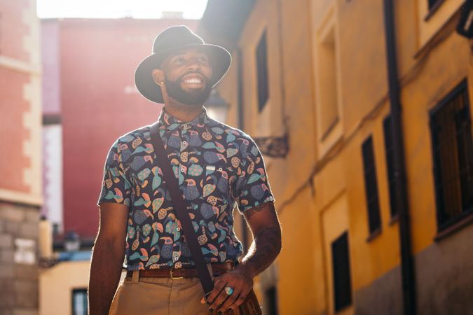 Stylish Black man walking on the city street