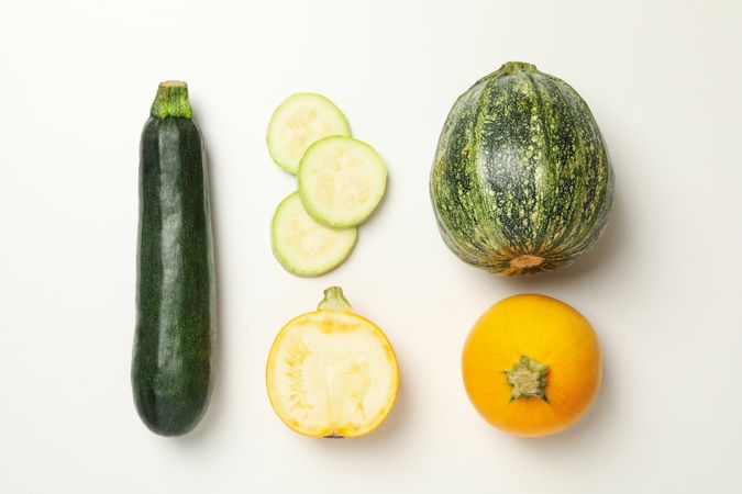Different zucchini on neutral background, top view