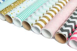 Rolls of festive wrapping paper on studio background. Space for text