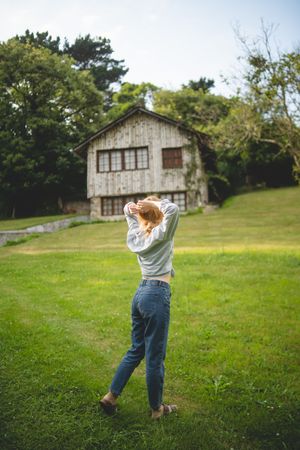Content female walking on grass in countryside