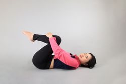 Young Woman doing Yoga Stretching Exercises
