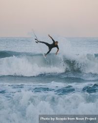 Man surfing on sea waves during sunset 42zzq4