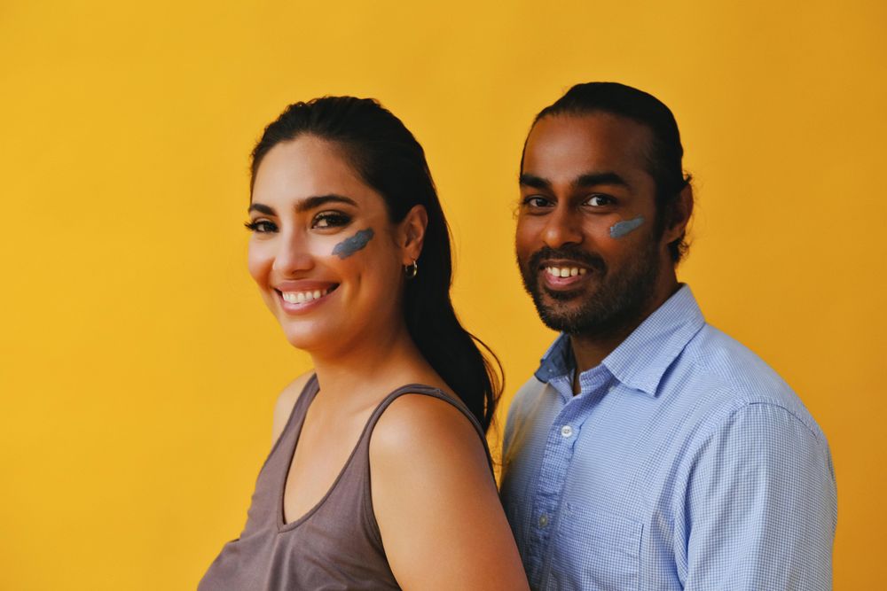 Smiling man and woman smiling with skin care on cheeks