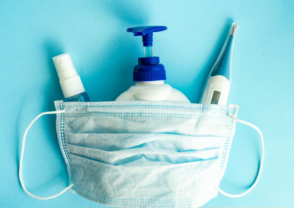 Top view of latex facemask with soap and thermometer in health care concept