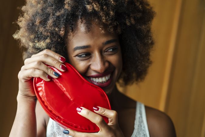 Smiling woman with lip shaped purse