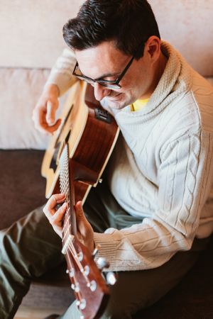 Man playing the guitar at home