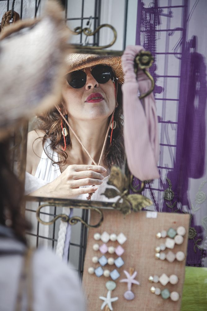 Female trying on hat looking at mirror