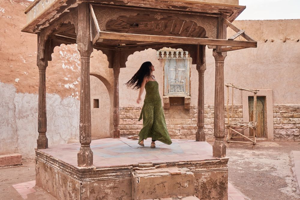 Woman dancing on street stage between ancient buildings