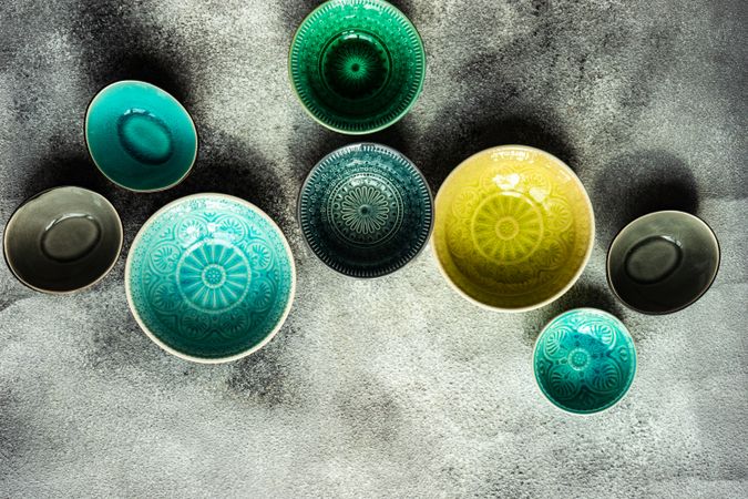 Empty bowls scattered on stone background