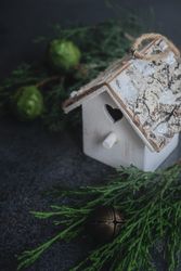 Christmas holiday concept of holiday bird house with branch