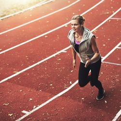 Woman racing on athletic track