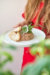 Unrecognizable woman holding plate with steak tartar