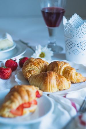 Homemade butter croissants with fresh strawberries