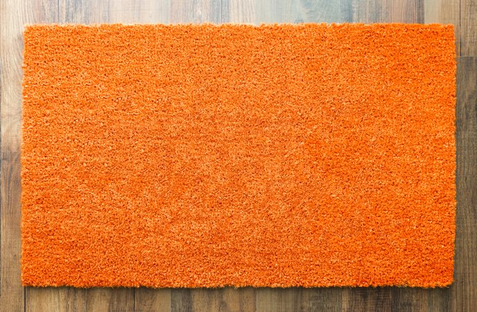 Blank Orange Welcome Mat On Wood Floor Background Ready For Your Own Text