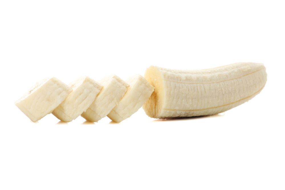 Chopped banana isolated on light background. Fresh fruit