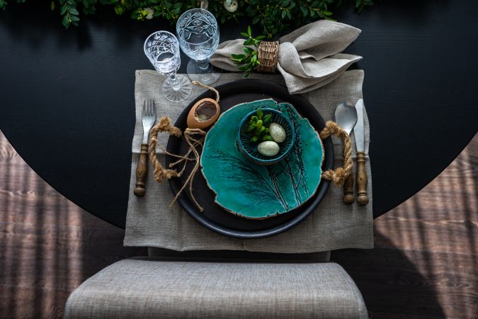 Looking down on Easter table setting with decorative teal plate