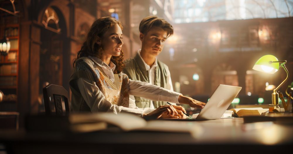 Engaged Young Couple Studying Together in a Vintage Library Setting