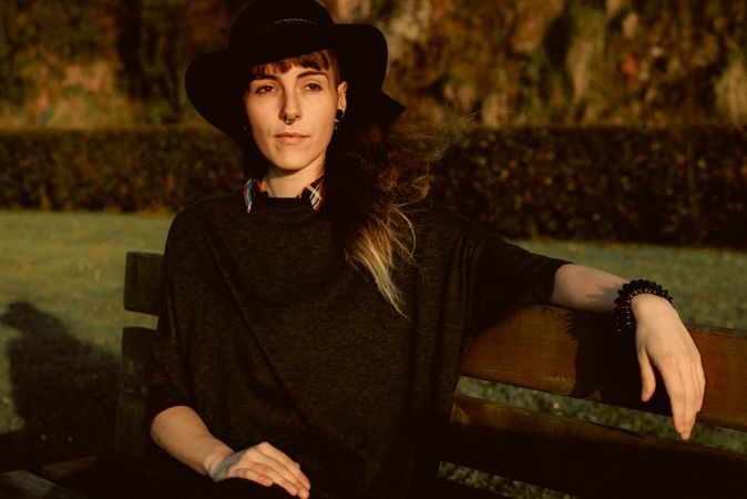 Stylish young woman in felt hat outdoors