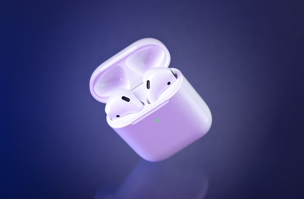 Futuristic wireless earbuds on blue