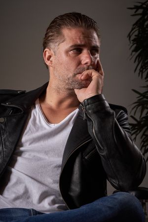 Pensive man sitting in barbershop