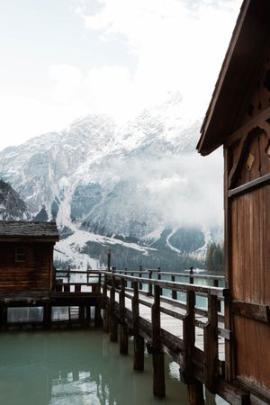 House on stilts on lake near mountains