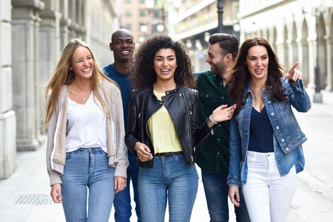 Friends walking down down city street and having a laugh