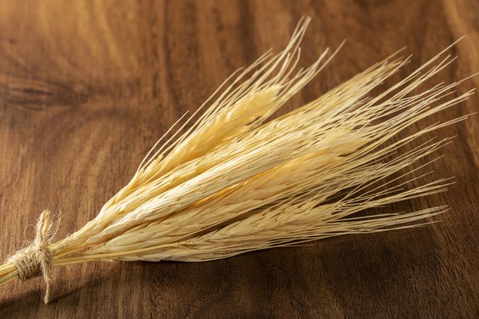 Ears of wheat on wooden background.