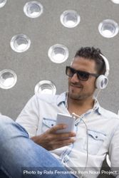 Happy male using headphones while holding phone 41Z8jb