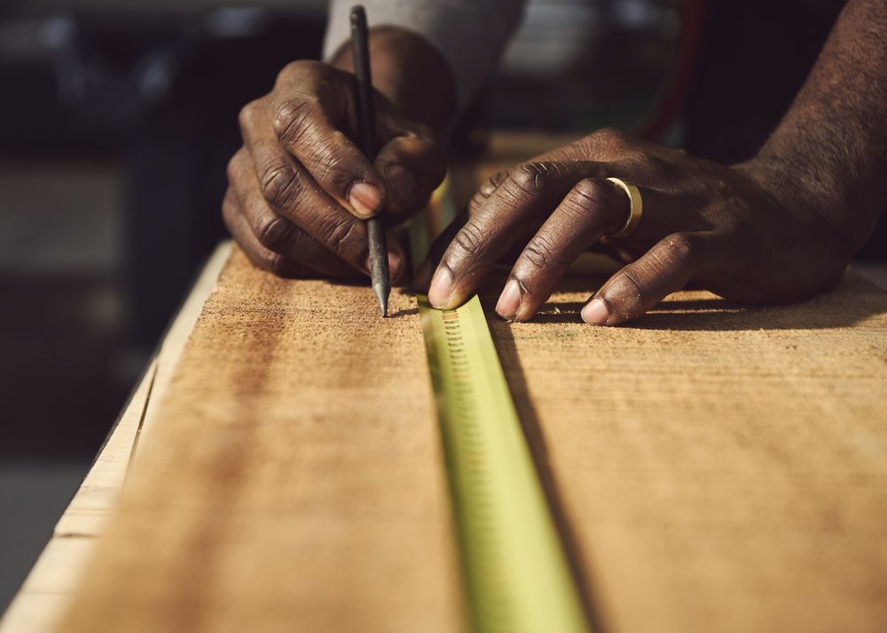 Close up of male hands measuring wood