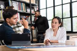Female architect presenting plans to colleague