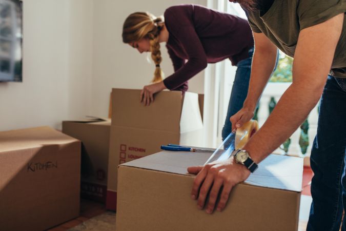 Couple packing their items to move into a new house