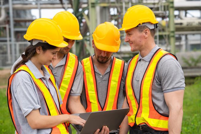Group of engineer workers checking project at petrochemical factory or refinery oil plant industrial.