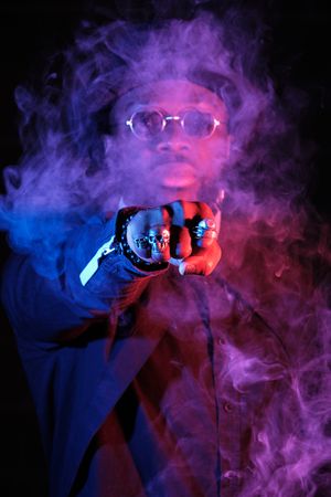 Serious Black man punching through vapor