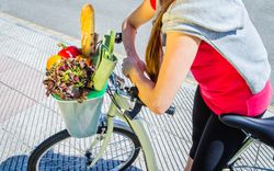 Closeup of woman winth groceries in a basket bike