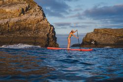 Woman on paddleboard floating in sea