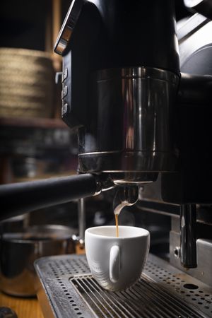 Barista making coffee using a coffee maker