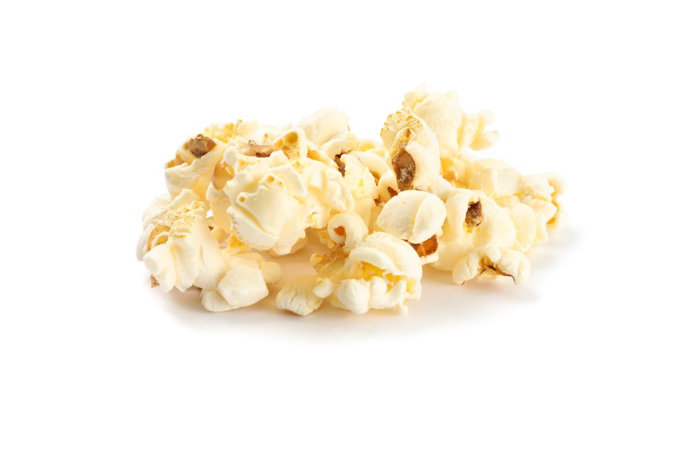 Popcorn pile isolated on blank background, close up