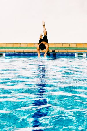 man jumps like fish into the water