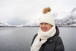 Joyful young woman in warm clothes