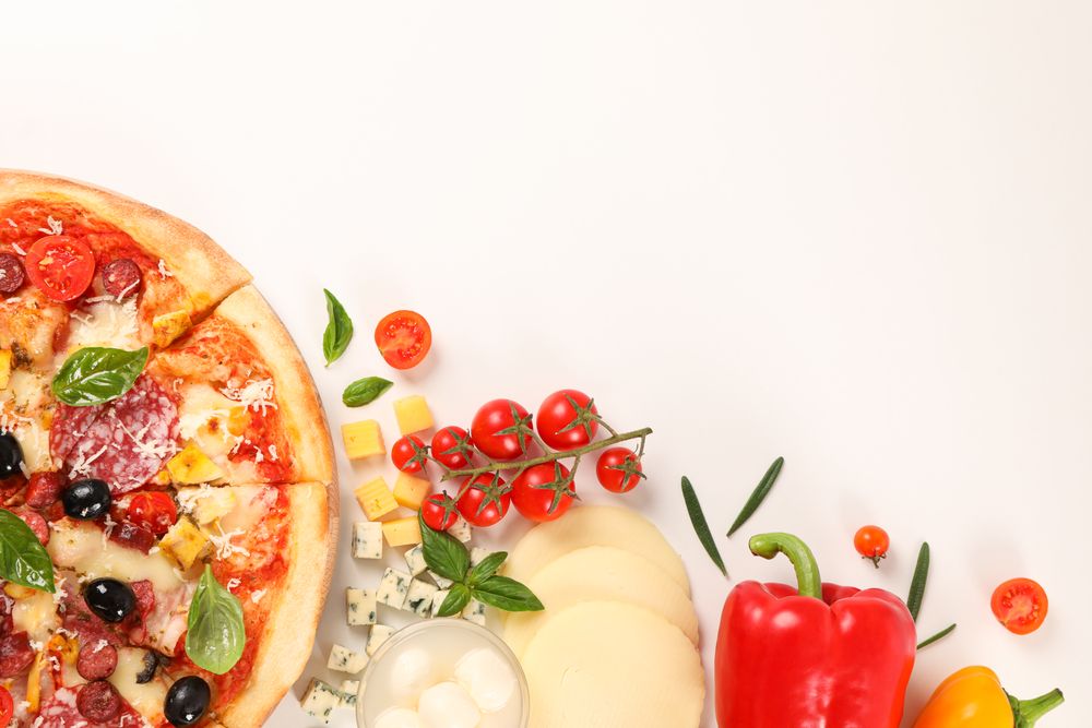 Flat lay. Pizza and ingredients: vegetables, cheese on plain background, copy space
