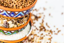 Close up of three colorful bowls full of different grains