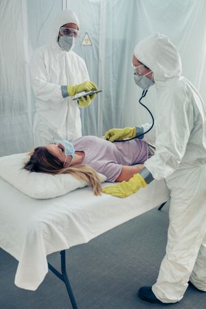 Doctors in a field hospital examining a patient