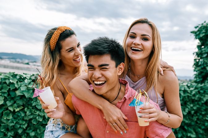 Happy man carrying his girlfriend on the back and having a good time
